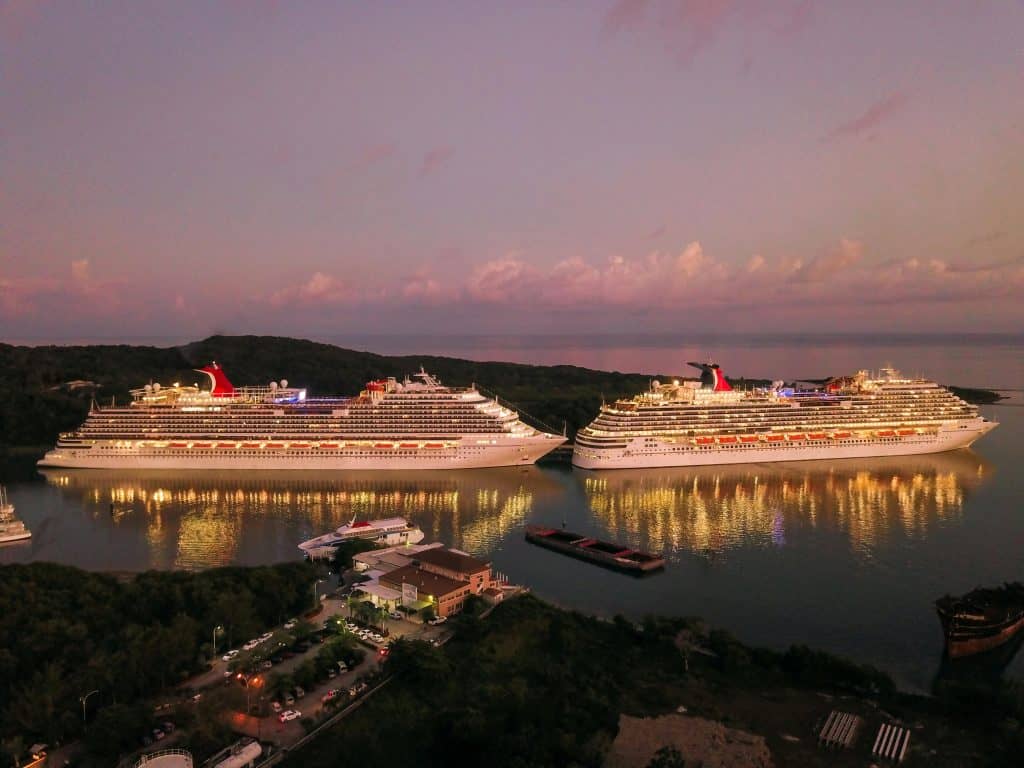 pexels-photo-2678418-2678418 Two illuminated cruise ships docked at Coxen Hole, Honduras during twilight.