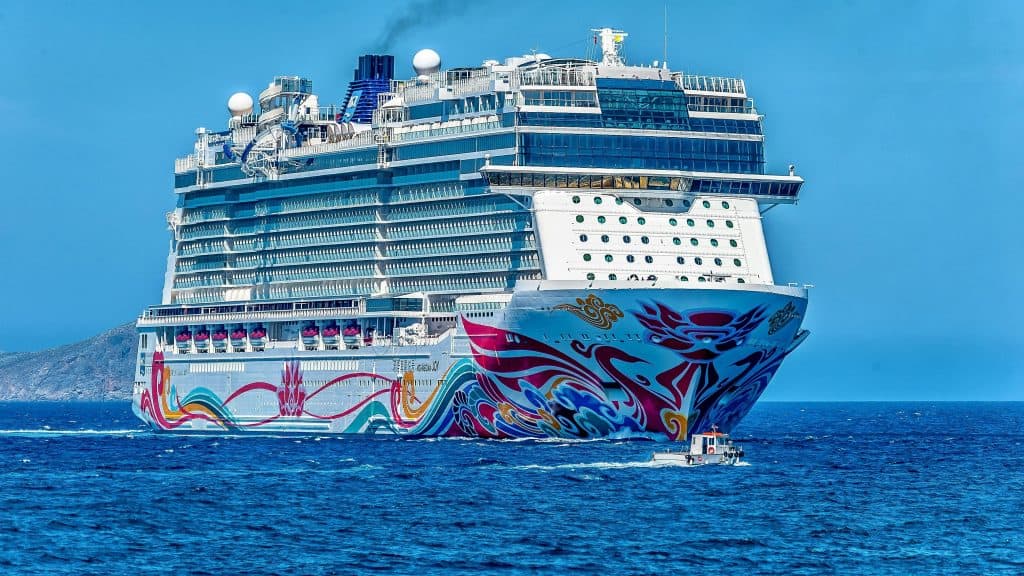 pexels-photo-945177-945177 A colorful cruise ship sailing on the open sea under a clear blue sky. Ideal for tourism and travel themes.
